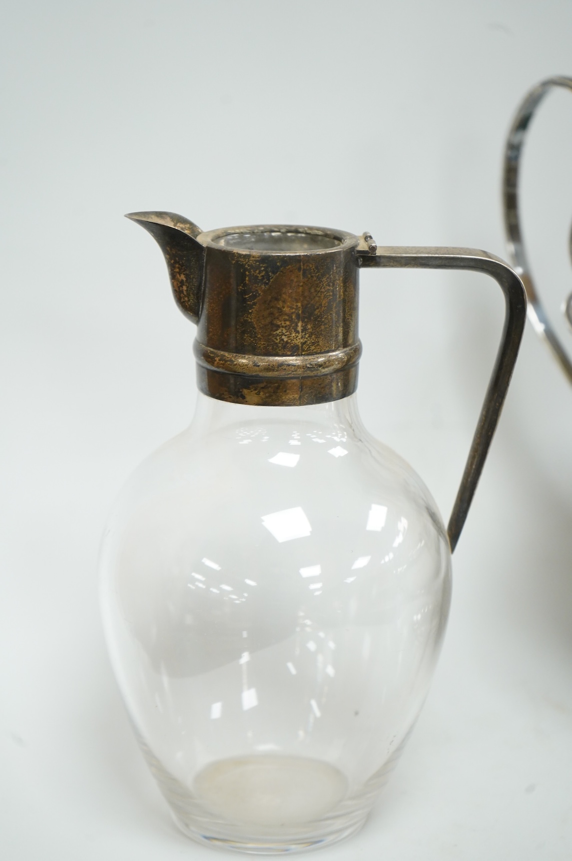 A late Victorian silver mounted claret jug (lacking cover), Holland, Son & Slater, London, 1882, height 21.1cm, together with a sterling sauce ladle, a plated two handled oval pedestal soup tureen and a cased set of six